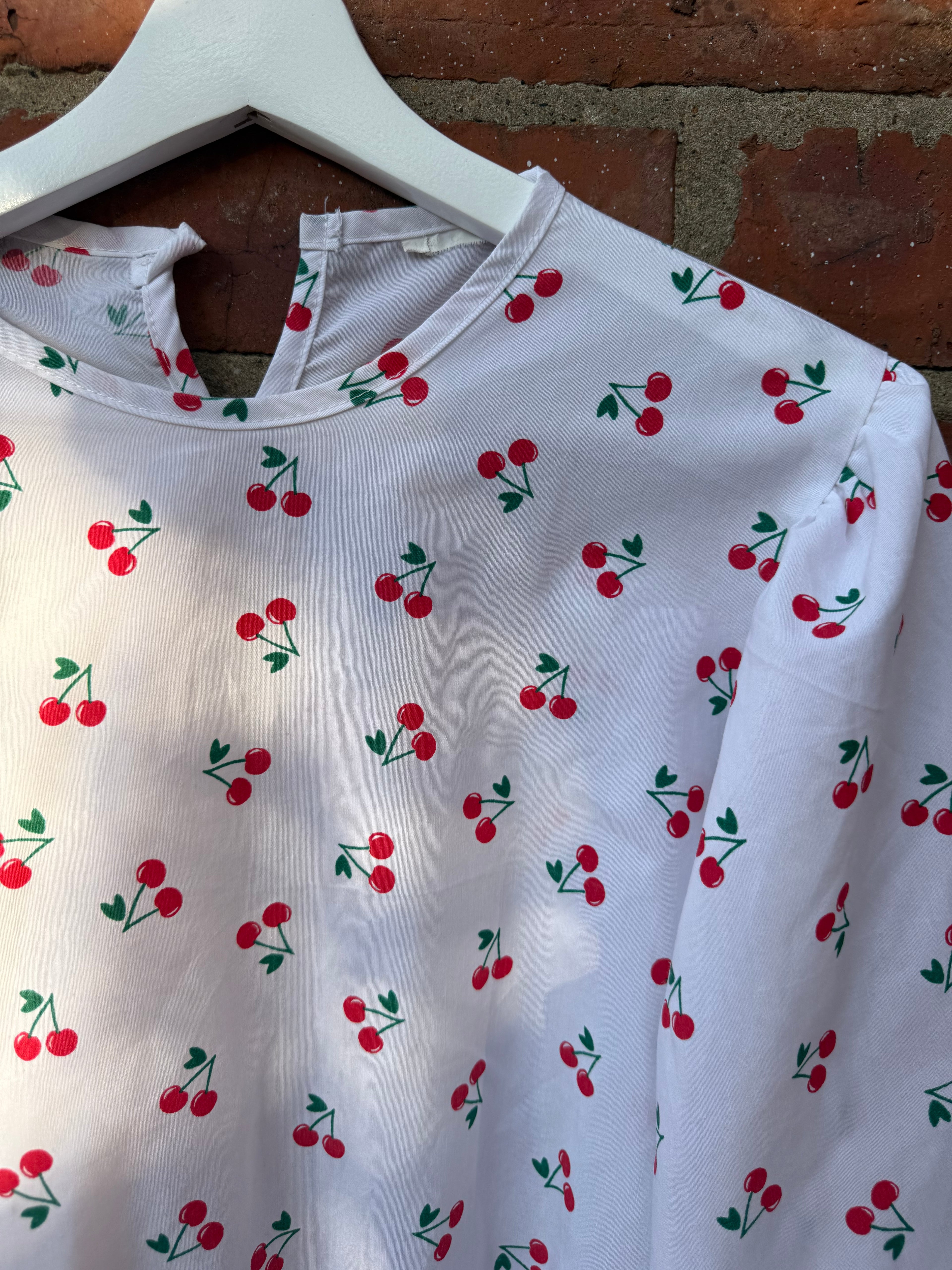 Women`s white balloon sleeve cherry print top