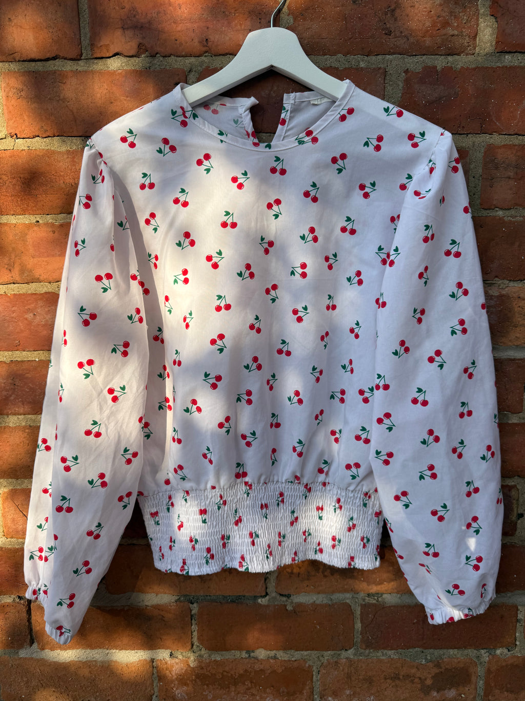 Women`s white balloon sleeve cherry print top